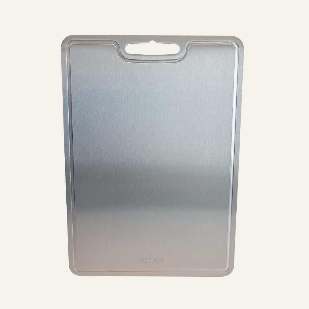 A rectangular metallic silver cutting board with a rounded handle cutout at the top, shown against a plain off-white background.
